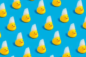 A patter of rubber duck toys isolated on a bright blue background. Kids' favorite bathing toy....