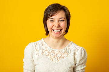 Laughing woman with crooked teeth in a stylish sweater smiles and happy.
