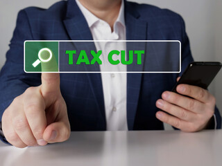  TAX CUT text in search bar. Broker looking for something at cellphone. TAX CUT concept.