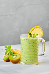 Cup with kiwi and lemon smoothie with mint