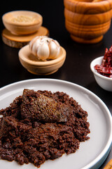 Beef Rendang is a Minang dish originating from the Minangkabau region in West Sumatra, Indonesia.  Rendang has been slow cooked and braised in a coconut milk seasoned with a herb and spice mixture