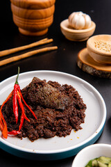 Beef Rendang is a Minang dish originating from the Minangkabau region in West Sumatra, Indonesia.  Rendang has been slow cooked and braised in a coconut milk seasoned with a herb and spice mixture