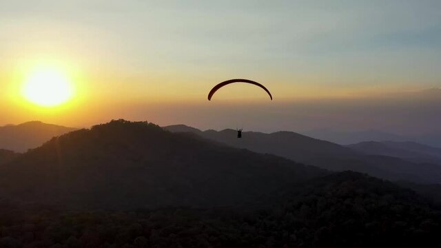Paragliding by the sun and the mountains.