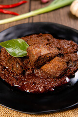 Beef Rendang is a Minang dish originating from the Minangkabau region in West Sumatra, Indonesia.  Rendang has been slow cooked and braised in a coconut milk seasoned with a herb and spice mixture