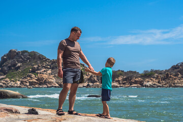 Dad son stand, walk spend time together. Nature sea mountain. Concept father day, family union...