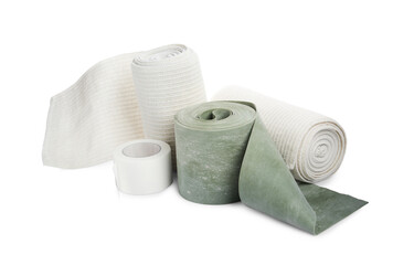 Medical bandage rolls and sticking plaster on white background