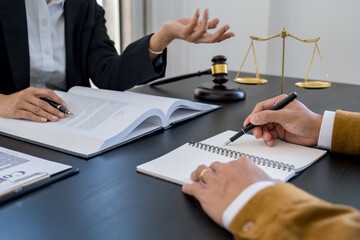  Judge gavel with Justice lawyers having team meeting at law firm background. Concepts of Law and Legal services.