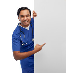 healthcare, profession and medicine concept - happy smiling indian male doctor or nurse in blue...