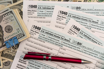 Tax Form 1040  with us 100 dollar banknotes
