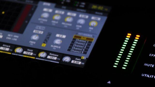 Blinking Lights on a panel of a sound console. Audio recording equipment on a concert in a club. Digital audio mixer closeup.
