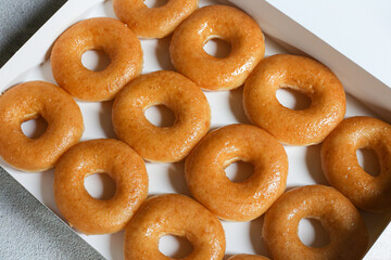 Glazed donuts original Delicious sugar pattern in box white, Selective focus.