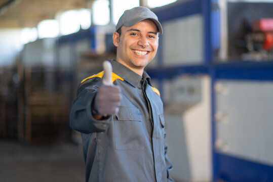Smiling mechanic giving thumbs up