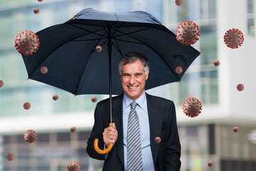 Businessman protecting himself from a rain of covid