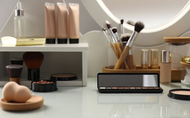 Many different cosmetic products on dressing table indoors