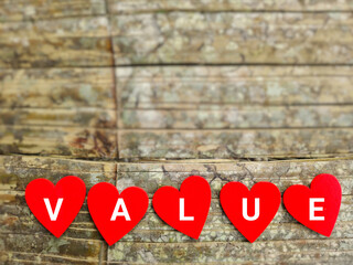 Value text with red heart shaped background. Stock photo.
