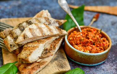  Grilled chicken fillets with  olive oil, chili pepper,   and tomato paste 