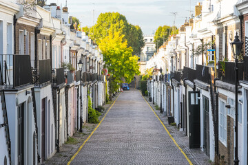 Row of terraced houses on cobbled Holland Park Mews in London