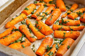 Homemade Roasted Carrots with Herbs, side view. Close-up.
