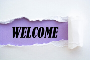 The word Welcome appearing behind torn white paper