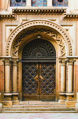 Obraz premium Ancient portal in the Residence of Bukovinian and Dalmatian Metropolitans (Chernivtsi National University).UNESCO World Heritage Site. Ornamented entrance doors. Chernivtsi, Ukraine