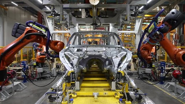 Robotic welding of a car body. Car production line. Selective focus