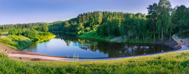 Moscow. June 19, 2021. Summer landscape in Meshchersky park. Nice view of the road along the pond