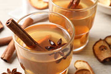 Delicious compote with anise and cinnamon on white table, closeup