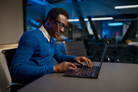 Manager In Glasses Works On Laptop In Night Offic