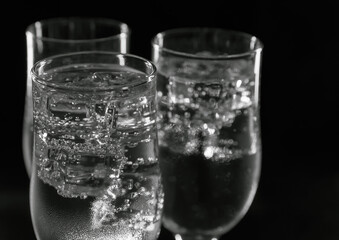 Cold drink in glasses with ice on a black background