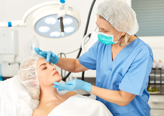 Doctor is examining woman patient before the procedure. High quality photo