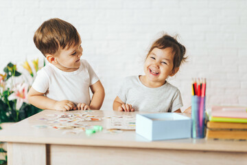 Boy and girl playing educational games in the school class