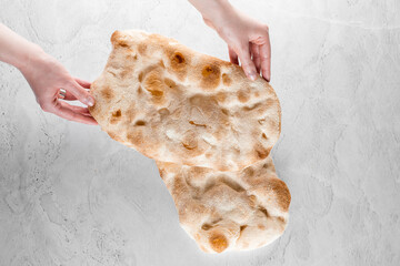 Touching and checking quality dough for pinsa romana on light background. Gourmet italian cuisine. - obrazy, fototapety, plakaty