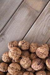 Fototapeta na wymiar Dried walnuts on wooden background
