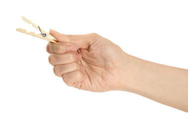Woman holding wooden clothespin on white background, closeup