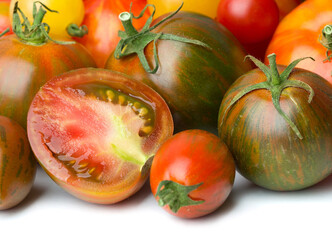heap of various tomatoes isolated on white backgound
