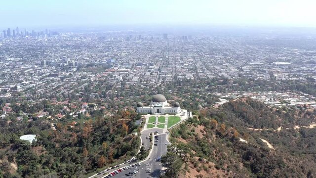 Aerial, Los Angeles skyscrapers and the Griffith Observatory Park, drone view 