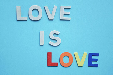 love word with wooden letters on the blue background for valentine's day