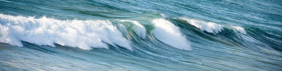 Breaking wave in a blue sea water