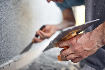 Man working on a house facade.
