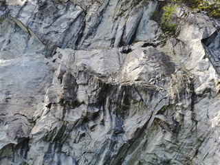 The steep slope of the flooded Marble Canyon in the Ruskeala Mountain Park on a sunny summer day.