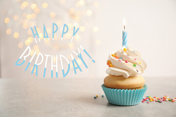Happy Birthday! Delicious cupcake with candle on light background