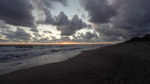 Beautiful sunset time lapse with sea and low moving clouds. 