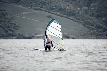 Naklejka premium Windsurfer surfing on a windy day at the river.