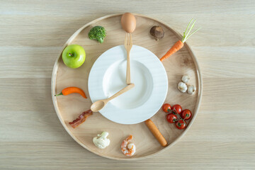Intermittent fasting IF and keto diet concept with hour clock timer for eating nutritional or...