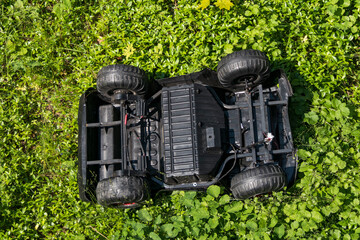 Stockholm, Sweden  A toy car turned upside down on the grass.