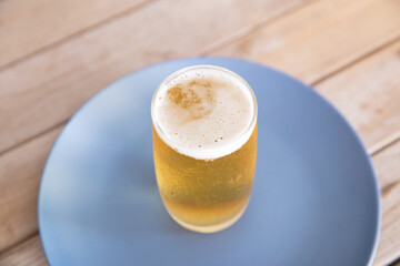 A glass of beer on the plate
