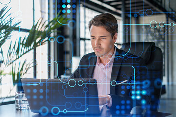 Handsome businessman in suit at workplace working with laptop to optimize development by implying...