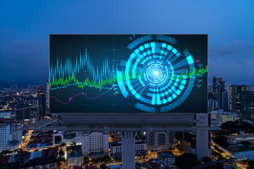 FOREX graph hologram on billboard, aerial night panoramic cityscape of Kuala Lumpur. KL is the developed location for stock market researchers in Malaysia, Asia. The concept of fundamental analysis