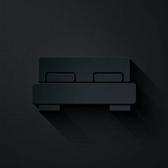 Paper cut Big bed for two or one person icon isolated on black background. Paper art style. Vector