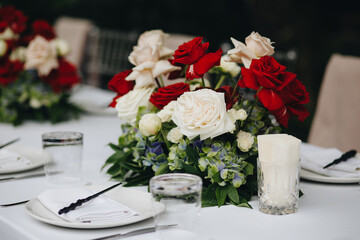 tableware Glasses, flower fork, knife served for dinner in restaurant with cozy interior